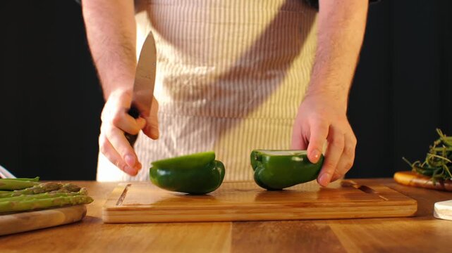 Man cut green sweet pepper, Healthy food, Chef hands with knife for onion, cutting and preparation with cooking for dish. Restaurant, culinary service and cook with skills for catering