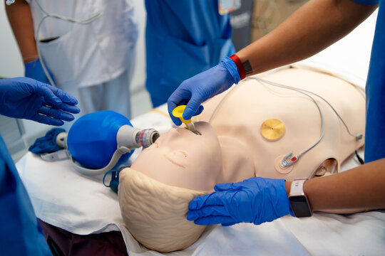 Healthcare professionals intubating a medical training mannequin