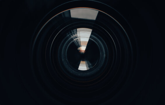 Close-up of camera lens aperture blades and optical elements,Macro,Detailed macro shot of a professional camera lens showing the mechanical aperture blades, iris diaphragm, and precision glass element