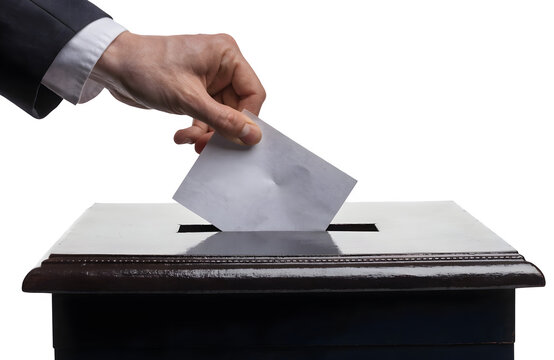 Closeup of a person in a suit casting a vote by putting a ballot paper into a wooden ballot box isolated on transparent background