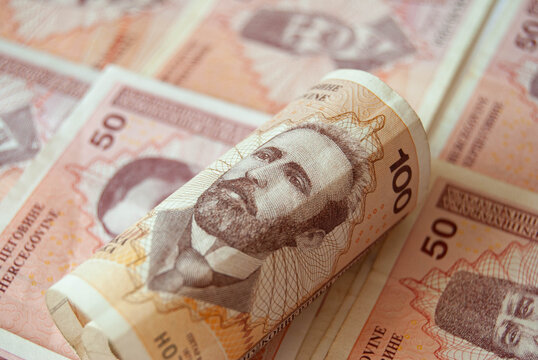 Bosnian paper money in close-up, featuring convertible mark banknotes with colorful patterns and traditional imagery.