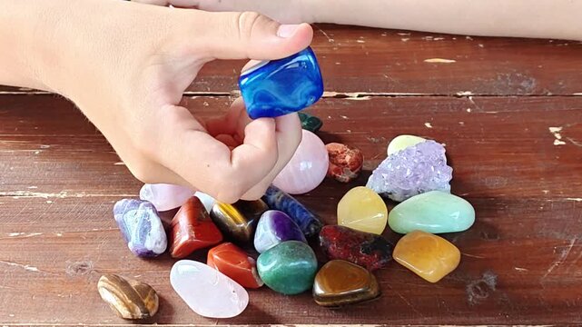 Natural minerals in hand. Semi-precious multi-colored stones, minerals close-up. Mineralogy. Collection of minerals.