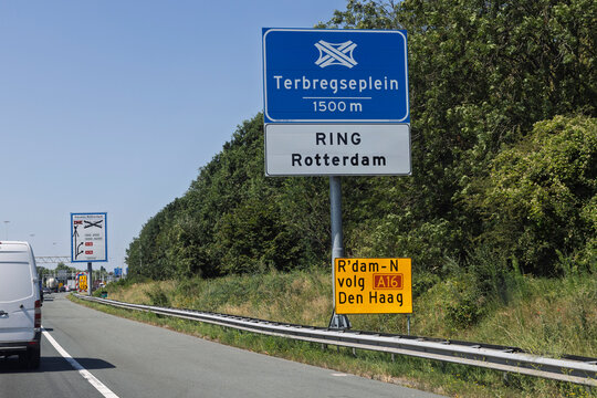 Rotterdam, Netherlands - Directional blue traffic sign on Dutch highway showing Terbregseplein interchange and Ring Rotterdam route on a sunny day.
