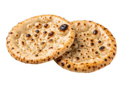 Two round toasted pita bread flatbreads with charred spots isolated on transparent background