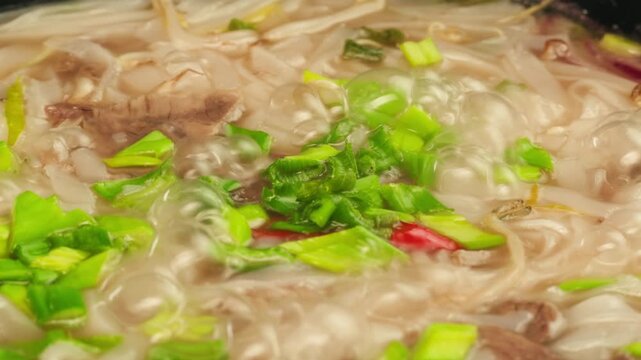Vietnam traditional pho bo soup on delivery, Beef noodles. Pho Bo Soup with beef, rice noodles, ginger, lime, chili pepper in bowl. Vietnamese cuisine. Pho Noodle Soup restaurant Close-up.