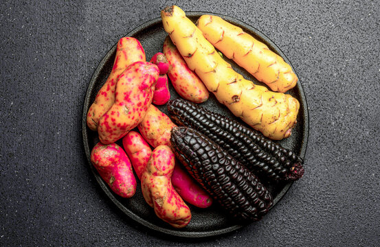 Peruvian raw ingredients for cooking black corn and sweet potatoes. Top view