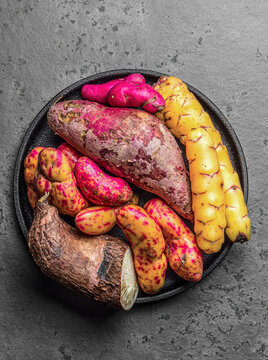 Peruvian raw ingredients for cooking - yuca, colored sweet potatoes and camote batata. Top view