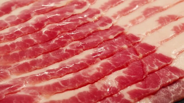  Sliced ham jamon fat bacon meat, beef pastrami thick pieces on a wooden board, beef or pork jamon. Chef cooking breakfast, smoked bacon in cafe. 