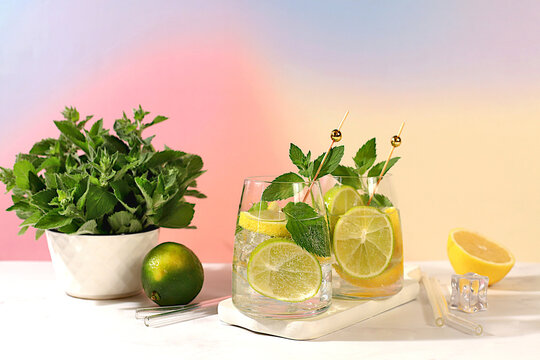 Icy homemade lemonade, juice or cocktail with mint, spearmint, lime, lemon and citrus, a refreshing summer drink recipe, a detox diet and weight loss concept, nonalcoholic mojito for energy