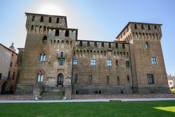 San Giorgio castle facade backlit by hazy afternoon sun with green lawn, Mantua, Lombardy, Italy © Michal Plevko