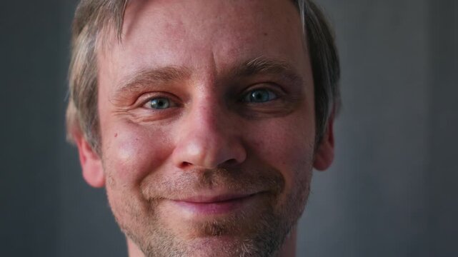 Smiling middle aged man 40 years old standing in office, portrait. Smiling blue eyes office worker, freelancer.