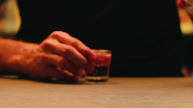 Pouring shot of red bitter, Cognac, whisky, Campari, Aperol, Cherry Vermouth Negroni, spanish wine drink, Alcoholic Americano Cocktail bitter, sweet vermouth and soda water, close up of making drink
