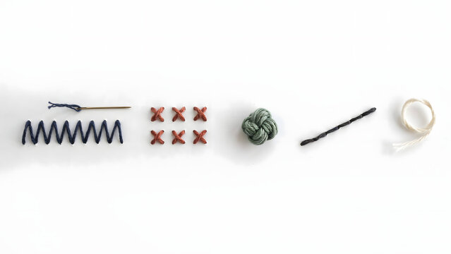Sewing needle, zigzag stitch, cross stitches, and thread spool isolated on a transparent background