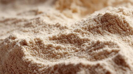 Obraz premium Fine beige powder texture in soft natural light with shallow depth of field for food or cosmetic backgrounds