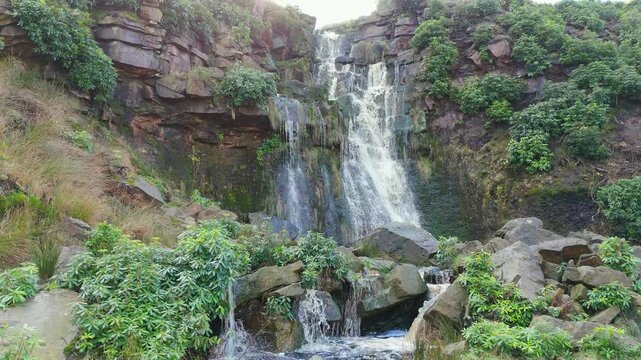 Aerial drone footage of a tall rocky waterfall in the Yorkshire Dales, Pennies. Moorland scene of a majestic waterfalls near Marsden West Yorkshire. Huddersfield Outdoors