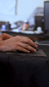Close-up of Man Hand Using Computer Mouse on Desk Mat in Workspace