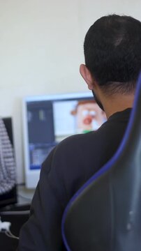 Video Editor Working on Editing Software Timeline on Computer in Modern Workspace