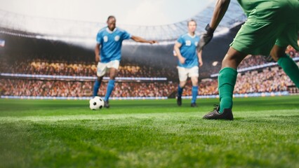 Obraz premium Selective focus captures a striker kicking the ball into the net for a winning goal in front of the goalkeeper, showing dynamic live match action and attacking movement on the pitch.