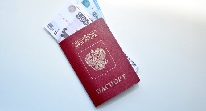 passport of a Russian citizen and invested rubles on a white background. pension, salary, loan or payment from a purchase or sale. fight against corruption and bribes