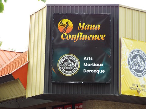 Gatineau,Quebec, Canada &ndash;  June 2, 2026:   A storefront sign displays the names "Mana Confluence and Arts Martiaux Derocque" on a commercial building at 10 Rue Belmont Ste 4A.