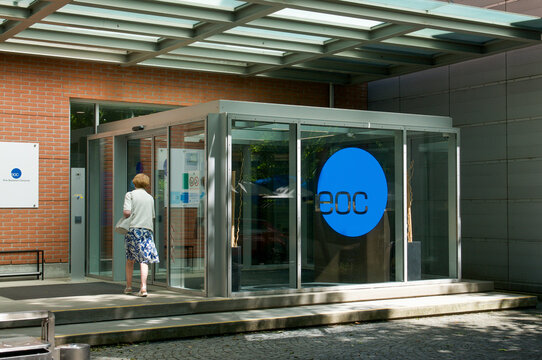 EOC Ospedale Italiano main glass entrance with walking patient or visitor in Lugano