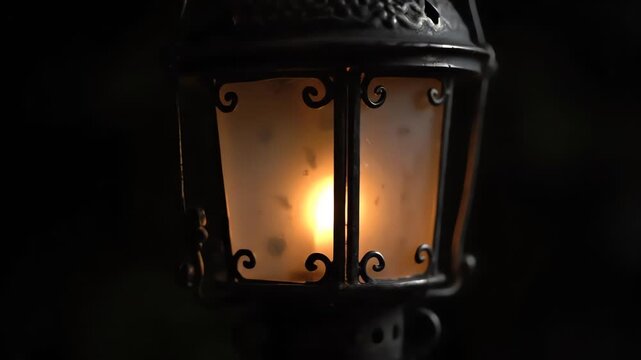 An ornate, metal lantern with a bright, diffused light glows in the darkness