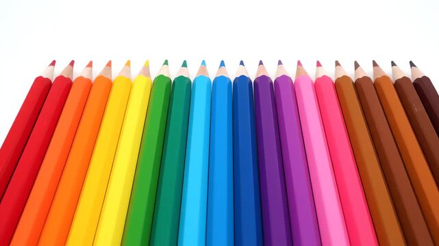 Array of colorful, sharpened pencils arranged in a chromatic spectrum on white