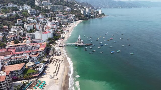 Aerial drone pull-back moving away from Los Muertos Pier in Puerto Vallarta