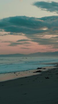 Ocean waves crashing on the beach before sunrise in relaxing nature