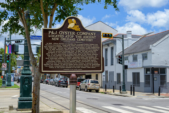 New Orleans, LA, USA - June 19, 2026: French Quarter Cityscape with Historic Marker for P&J Oyster Company in Foreground and P&J Oyster Company Blurred in Background