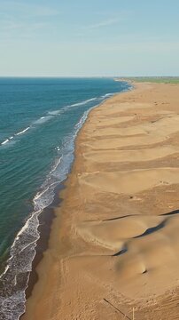 Aerial view of Mediterranean coastline and sand dunes in Ebro Delta Natural Park, Deltebre, Catalonia, Spain