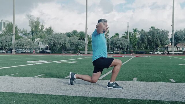 Healthy exercises. Active man exercising outdoor. Exercising and warming up. Senior man training leg muscle doing lunges exercise. Man in fitness do lunge exercising outdoor
