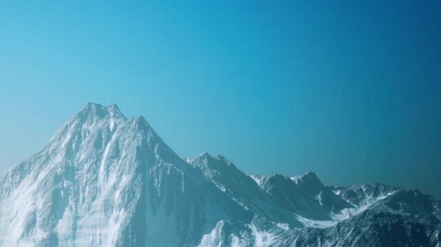 Snow covered mountain range stands tall against a bright blue sky during the day. The sunlight highlights the sharp edges of the peaks. Nature shows its beauty and strength.