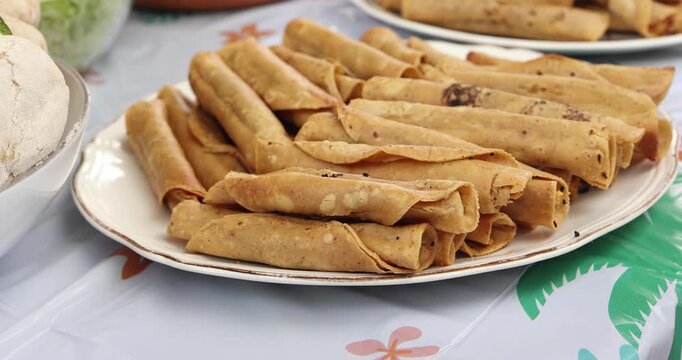 flautas de pollo or chicken fried tacos in Mexico Latin America, Mexican feast with Homemade food on table