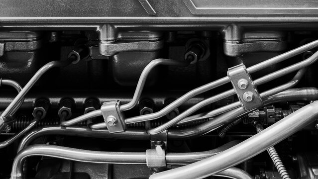 Shown is a large engine with many tubes, bolts and various parts. Auto service concept background