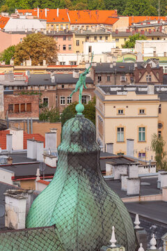 Copper dome with Hermes statue above historic rooftops in Swidnica, Lower Silesia, Poland