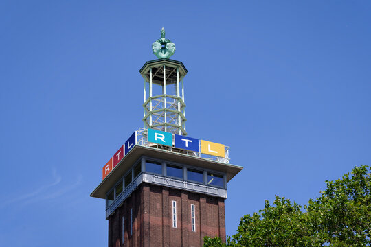 Cologne, Germany July 21 2026: Close-up of the historic Messeturm in Cologne, Germany, featuring the colorful RTL television network logo and the unique tower top under a blue sky.