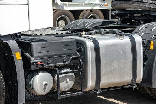 Semi truck aluminum fuel tank and compressed air receivers. Heavy duty commercial transport vehicle chassis component with battery box and long haul tractor engineering technical details.