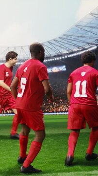 Portrait format: Blue soccer player showing ball control and dribble skill in attack action on pitch, dribbling past red opponent in dynamic match, footwork and one on one possession duel.