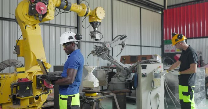 Technicians Troubleshoot Robotic Arm Control System for Automation Maintenance