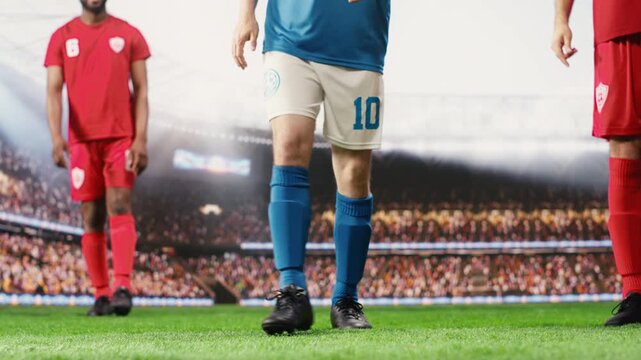 Soccer striker prepares for a free kick and goal attempt for the blue team, focusing technique on hitting the ball forward into the net in low angle pitch action.