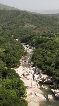 People swimming in mountain river in tropical jungle