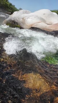 Clear mountain river water flowing over rocks