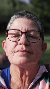 Yoga, Senior woman enjoy meditation relax training in nature park - Wellness, healthy life style and anti-stress practice - Vertical video