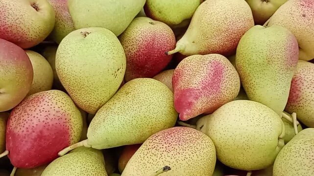  Close up video of fresh ripe pears with red blush in a pile