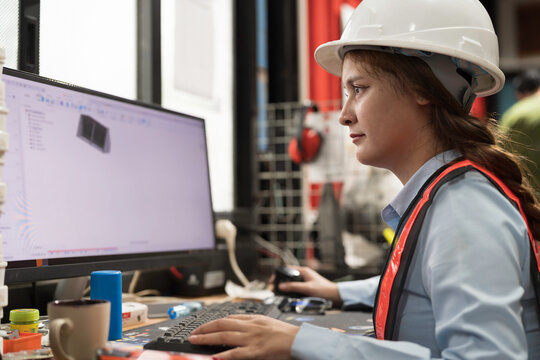 Woman engineer using desktop computer for design project work or training programmable logic controller or programmable controller