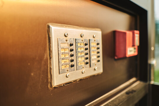 Weathered apartment buzzer panel with handwritten numbers