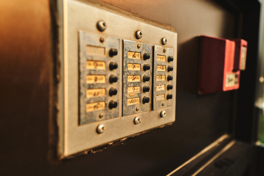 Apartment buzzer panel beside a red fire alarm pull