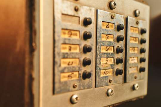 Close-up of worn apartment intercom buttons