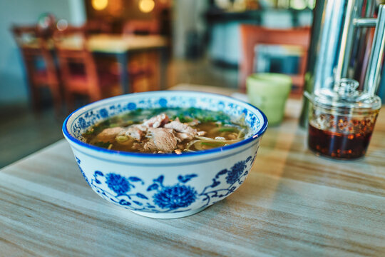 Bowl of beef pho on a restaurant table